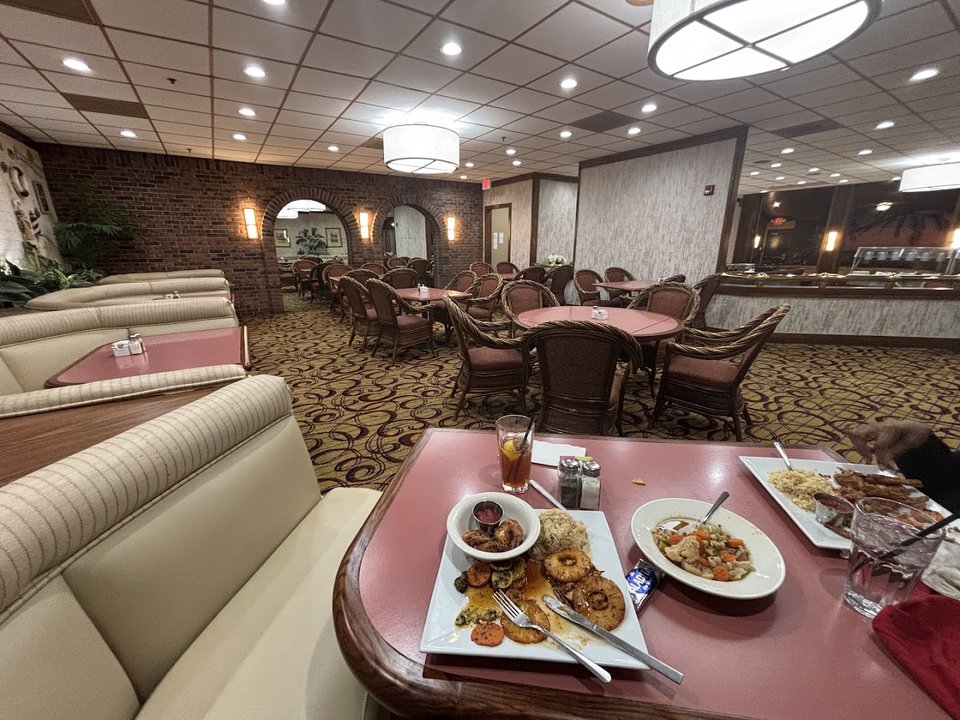 A cozy restaurant dining room with booth seating.